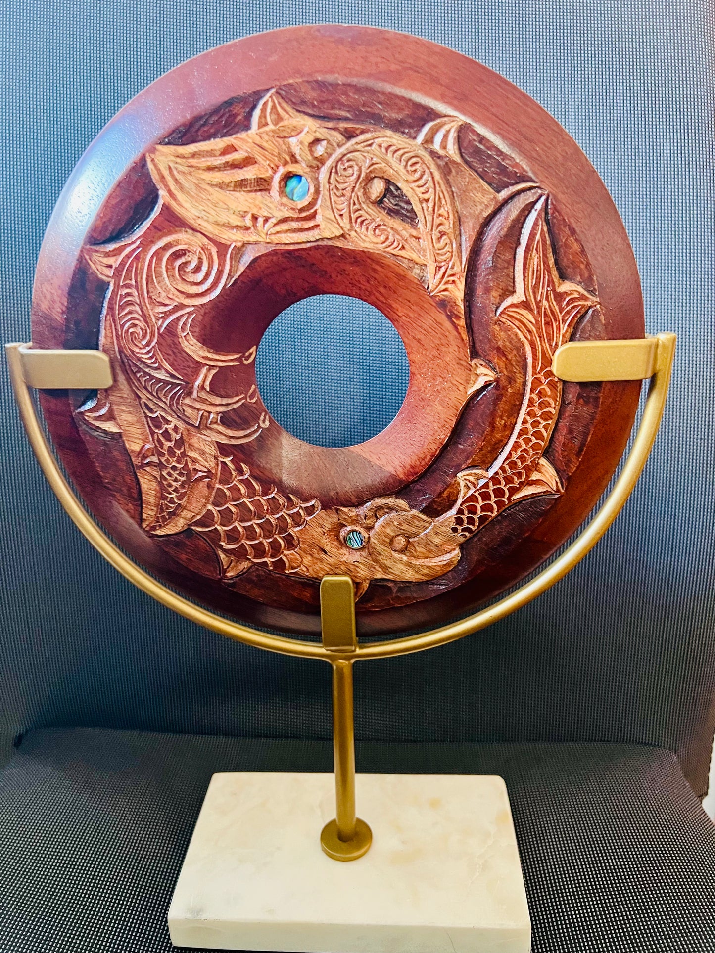 Manaia whakairo on brass/marble base